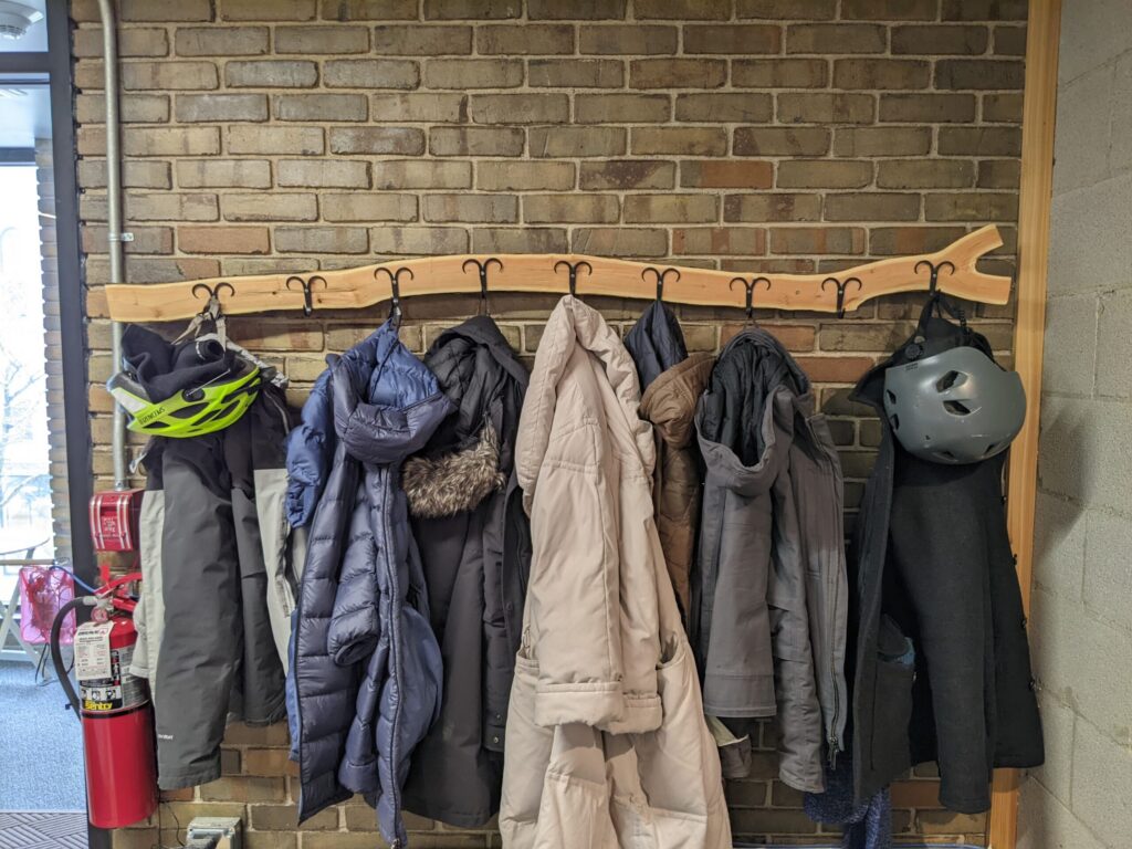 the finished coat rack with coats on it