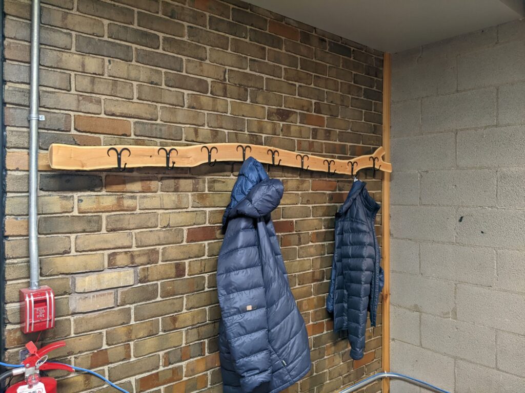 coat rack with two coats hanging on it