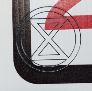 extinction symbol burned into a plastic sheet