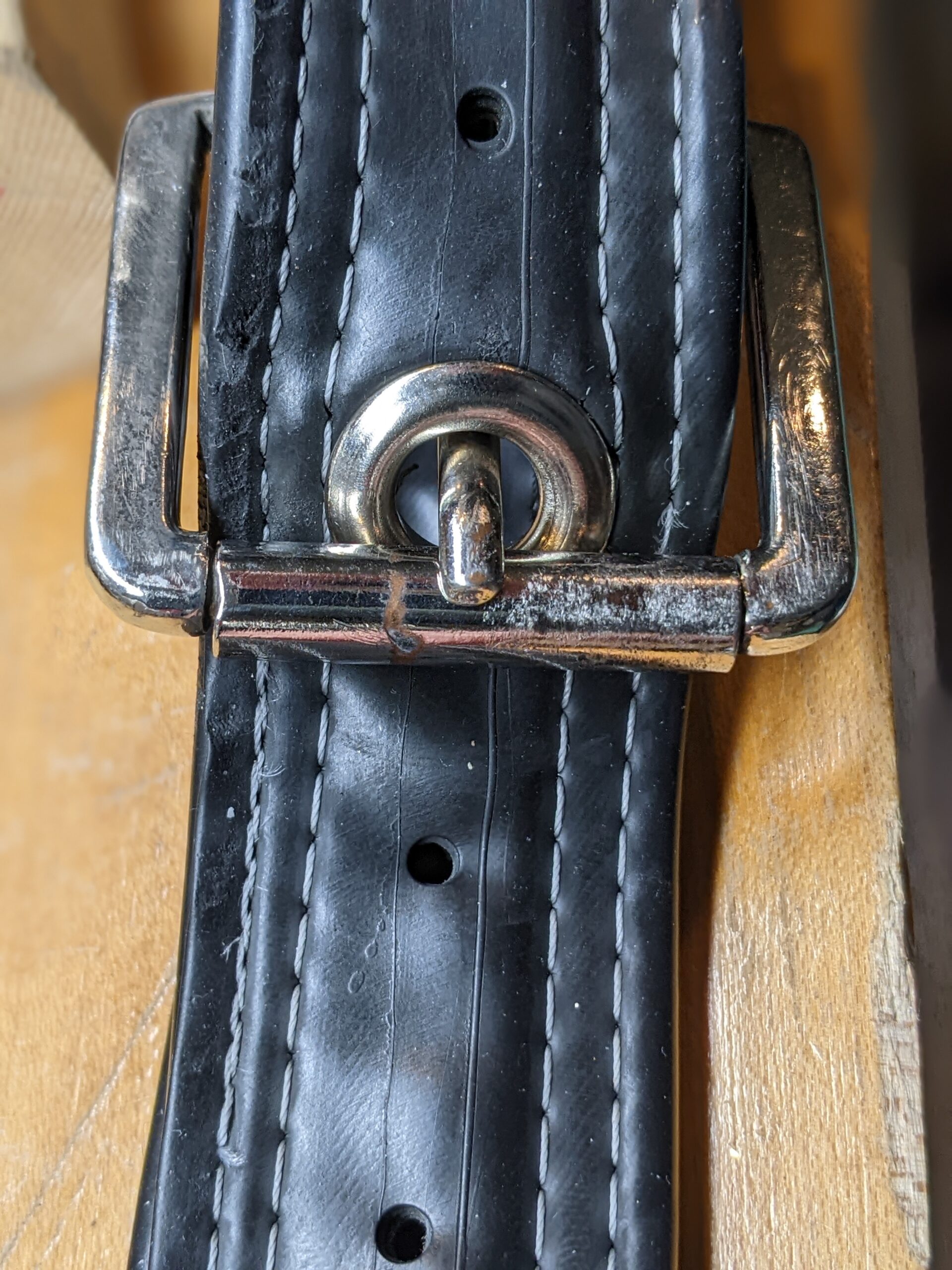 the closed belt, with the long skinny poker thing inserted through the grommet and held against the bar.